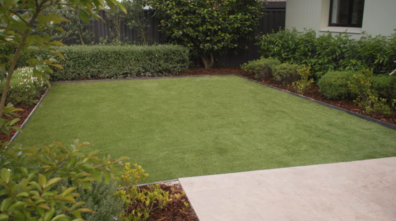 Beautiful residential artificial grass installation in Pittsburg backyard with green synthetic turf